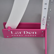 A close-up of the Hobby Horse LarDen Puissance Jump in pink and white, featuring numbered height markers—ideal for practicing your next Hobby Horse Puissance challenge.