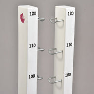 The Jump set for Hobby Horsing by Hobby Horse LarDen features two white vertical posts with metal brackets at 100, 110, and 120 heights, ideal for jumps or cavaletti. The left post is topped with a red fox logo. Background is plain gray.