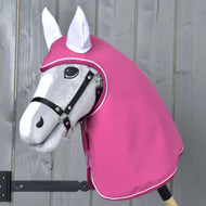 Impermeabile Larden di Hobby Horse LarDen su un Hobby Horse grigio con briglia nera e cappuccio rosa impermeabile, esposto davanti a una parete di legno.