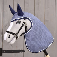 The Hobby Horse LarDen Raincoat Jeans features a plush horse head with a black bridle and blue raincoat hood with ear covers, shown against wood—ideal for imaginative play in any weather.