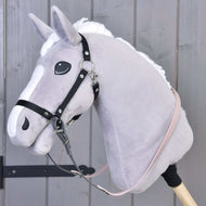 Primo piano di un Hobby Horse LarDen con testa grigio chiaro, criniera bianca e Redini gommate Dark Grey/Pink, fissato a un bastone color crema su sfondo in legno.