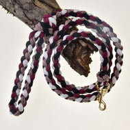 Hobby Horse - Corda intrecciata nero/bianco/bordeaux di Hobby Horse LarDen, appesa arrotolata su un ramo d'albero, con fermaglio in metallo dorato a un'estremità.
