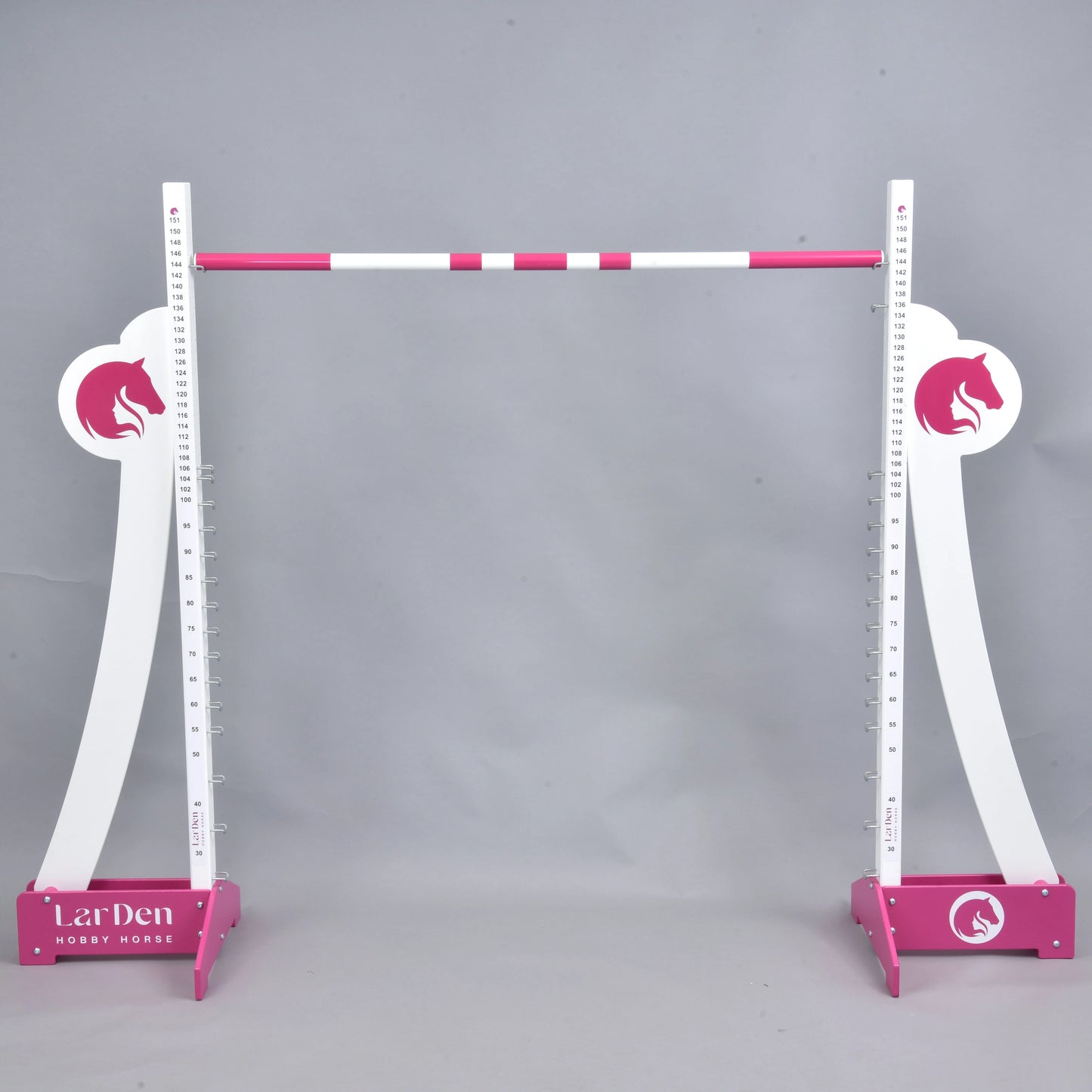 The Hobby Horse LarDen LarDen Hobby Horse Puissance Jump, in pink and white with horse head silhouettes and striped bar, stands against a plain gray background—ideal for Hobby Horse Puissance training.
