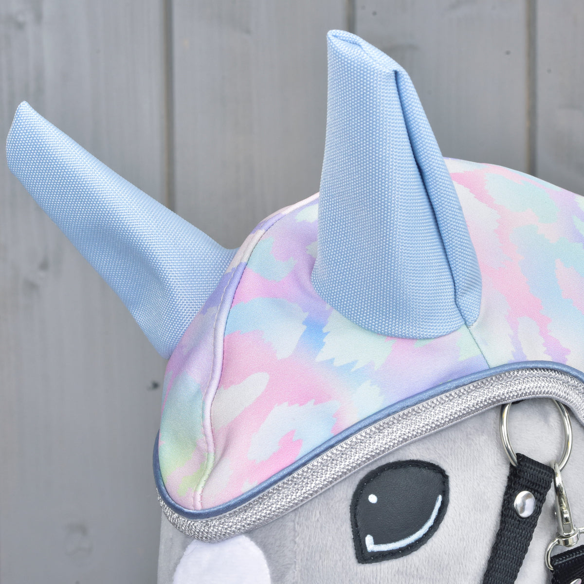 Close-up of the pastel patterned raincoat hood with blue ears and silver trim on a Hobby Horse
