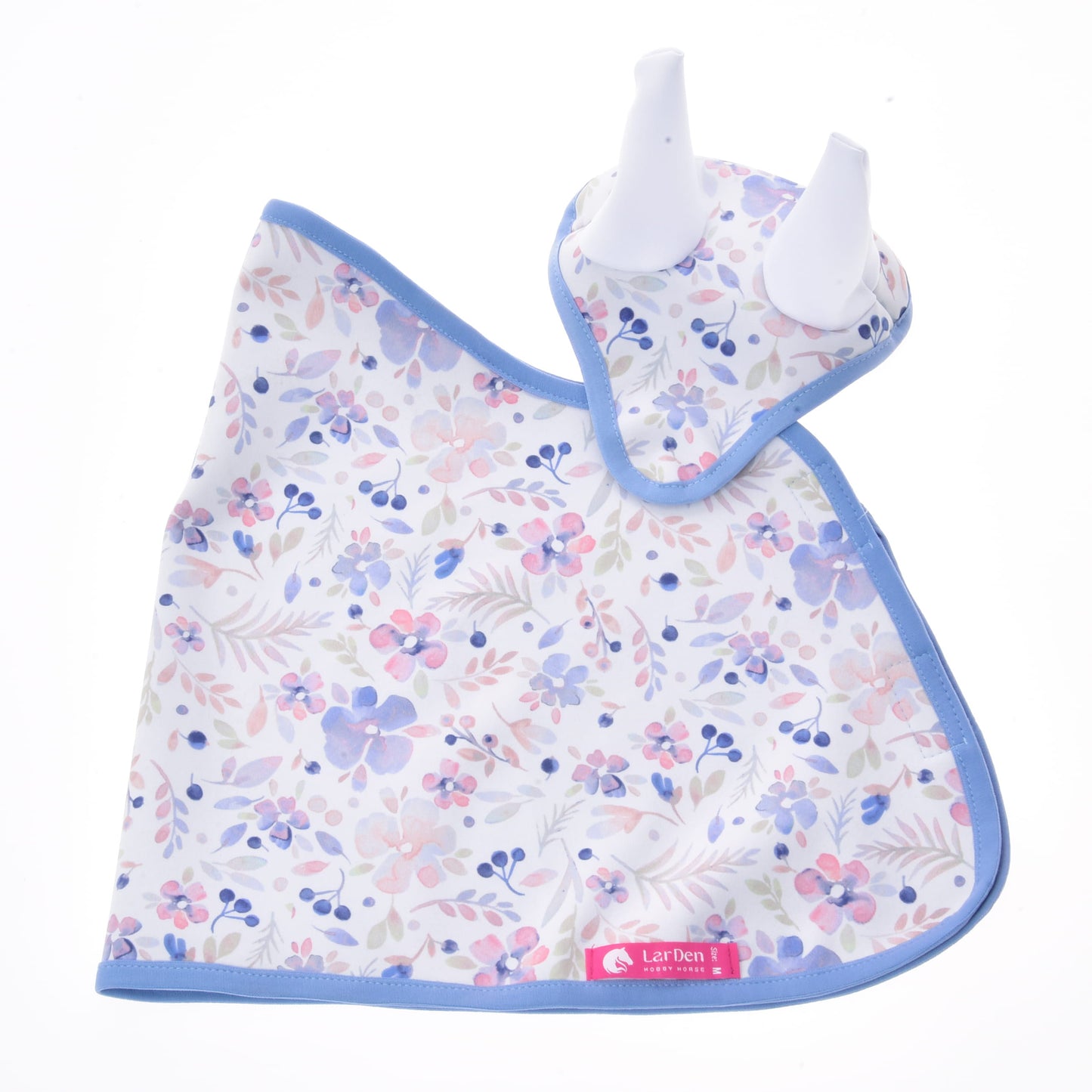 Set Vanessa NEW di Hobby Horse LarDen con bavaglino per neonato e massaggiagengive coordinato con bordo blu, entrambi con motivo floreale rosa, viola e blu su fondo bianco. Il massaggiagengive ha due punte bianche in silicone a forma di orecchie, rendendolo un grazioso set per la cameretta.