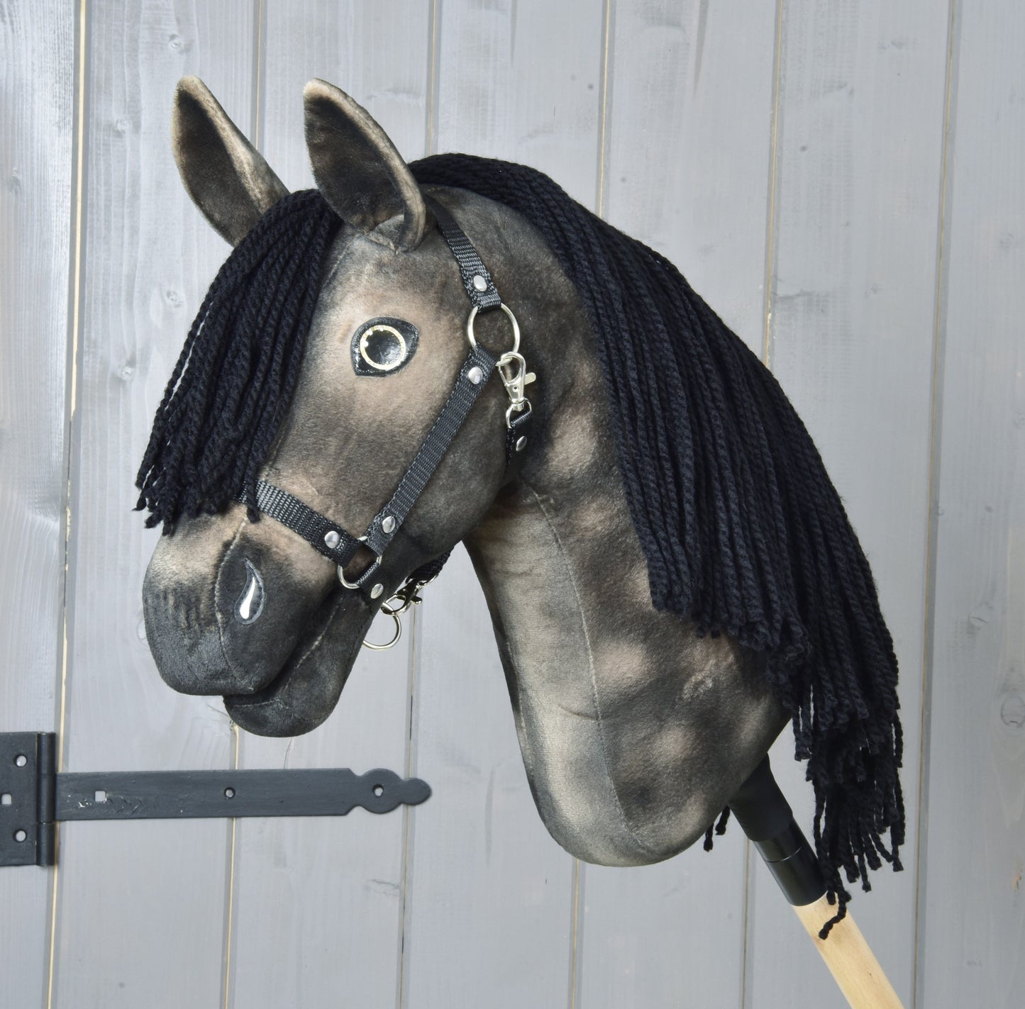 Hobby Horse Stormy with Black Halter by Hobby Horse LarDen, a dapple grey Art Collection hobby horse with dark muzzle, black forelock and black halter, mounted on a wooden stick.