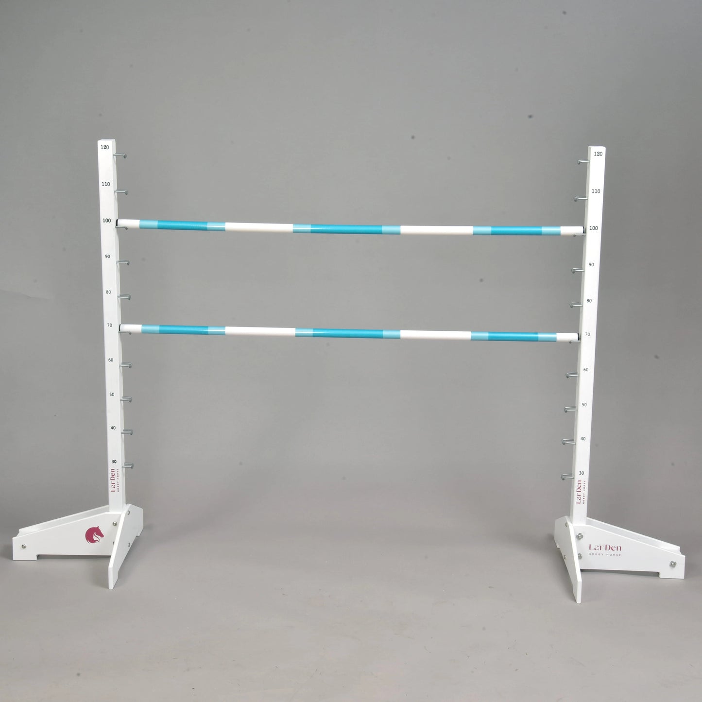 The Hobby Horse LarDen Jump 120 cm / 47 inch set includes two white and blue-striped vertical posts with numbered markers and two horizontal poles made of sturdy wood, shown against a plain gray background.
